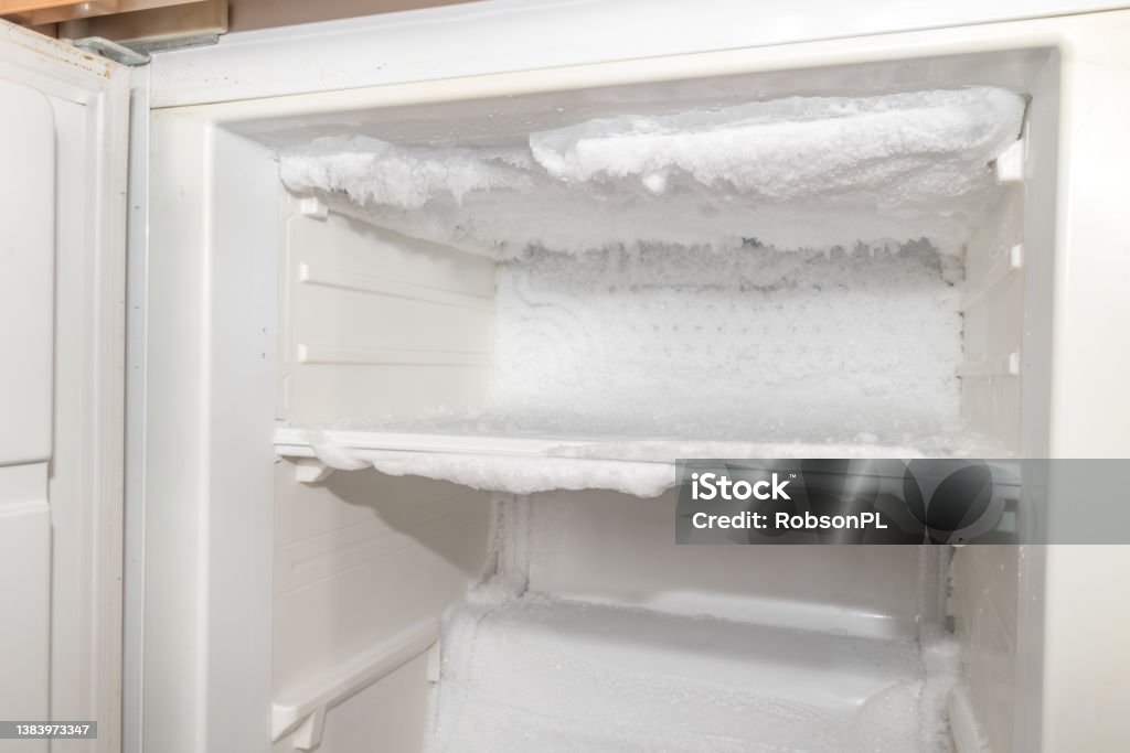Ice inside a fridge. Defrosting freezer. Refrigerator Stock Photo