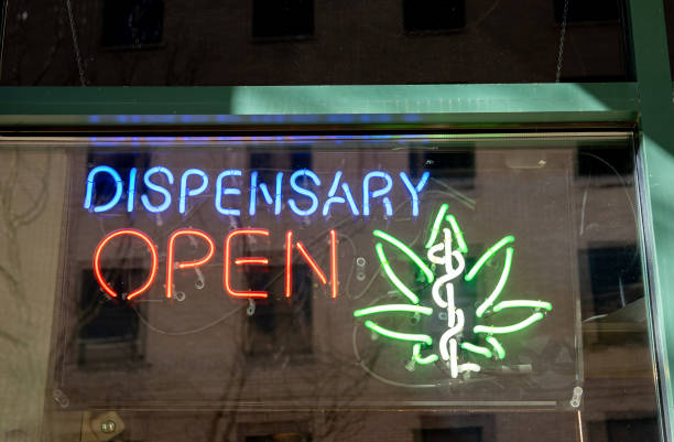 Medical marijuana dispensary sign Neon sign advertising legal, medical marijuana dispensary in store window. cannabaceae stock pictures, royalty-free photos & images