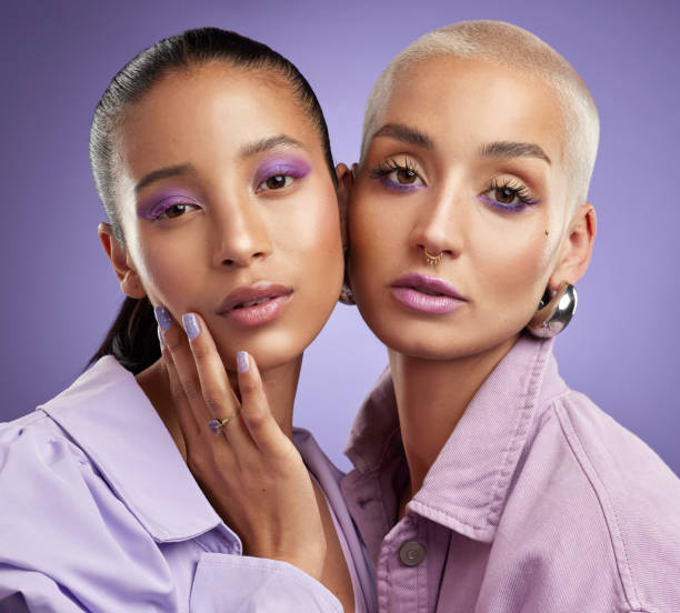foto de dos hermosas mujeres jóvenes posando en púrpura - alta costura fotos fotografías e imágenes de stock