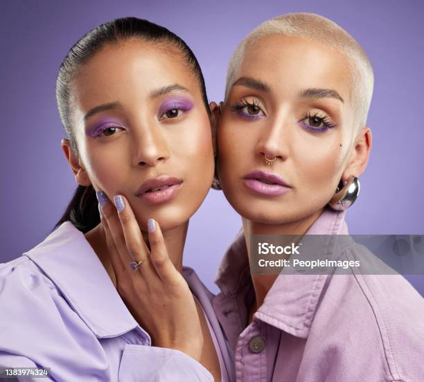 Shot Of Two Beautiful Young Women Posing In Purple Stock Photo - Download Image Now - Make-Up, Women, Beauty