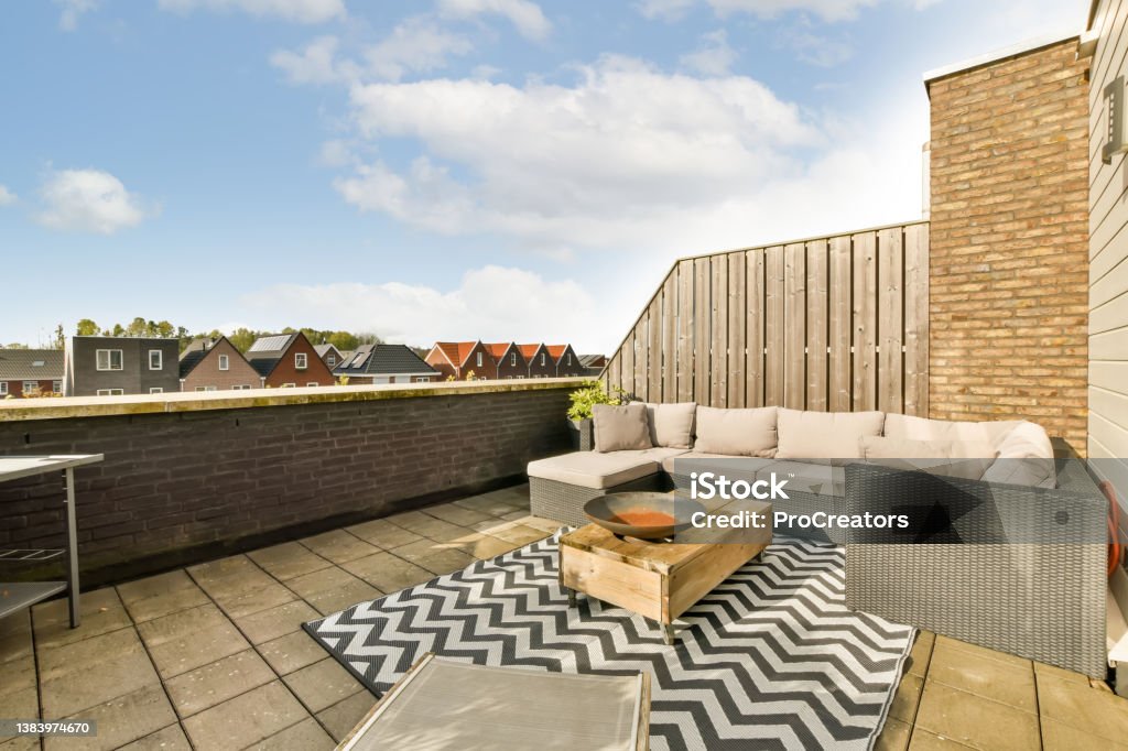 Cozy place to relax on the roof Cozy place to relax on the roof of a modern house with a corner sofa and a pleasant interior Patio Stock Photo