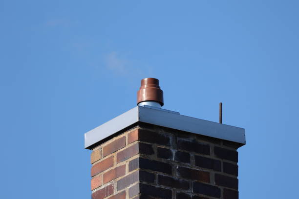 istock Red brick chimney against a blue sky 1383974827