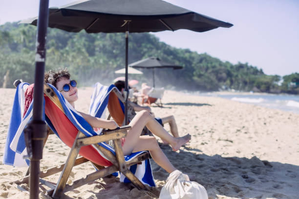 istock Young women relaxing on the beach 1383975466