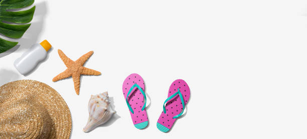 istock Summer concept with a straw hat, sunblock, starfish, and beach sandals 1383977539