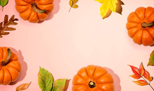 istock Autumn pumpkins with colorful leaves overhead view 1383977593