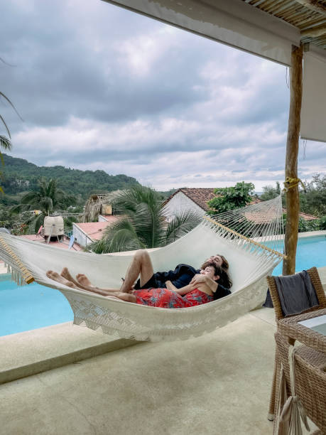 istock Young couple in a hammock 1383977742