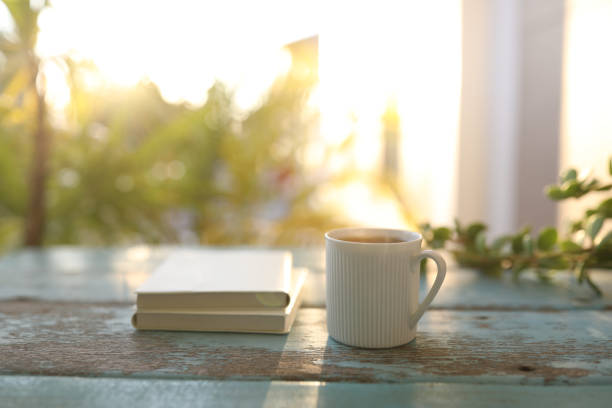 istock Coffee mug and notebook on weathered blue wooden table 1383978664