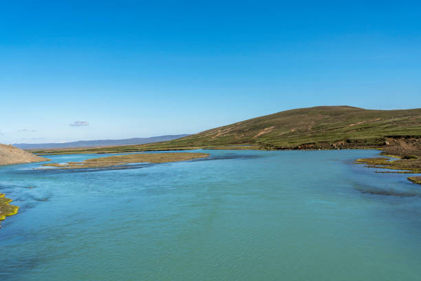 Beautiful turquois color river flowing under the road to Kerlingarfjöll camp site, the river from melting glacier, Iceland