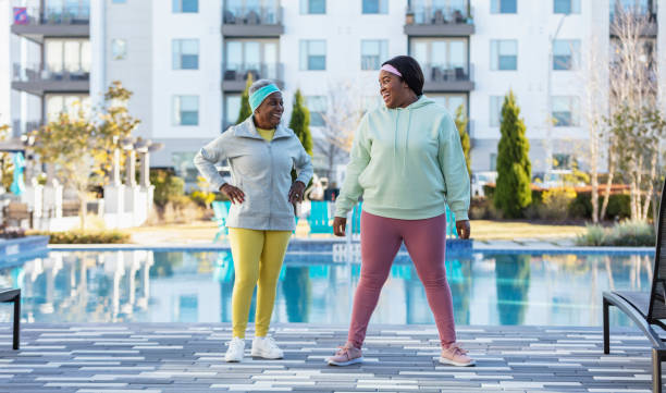 istock Two African-American women working out on pool deck 1383980966