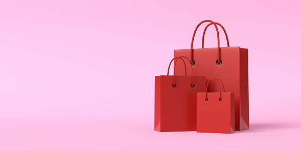 Red shopping bags on a pink background with copy space. Creative minimal concept. 3d render 3d illustration