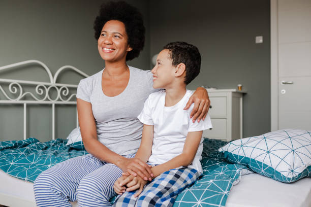 istock Mother and son sitting on the bed 1383983874