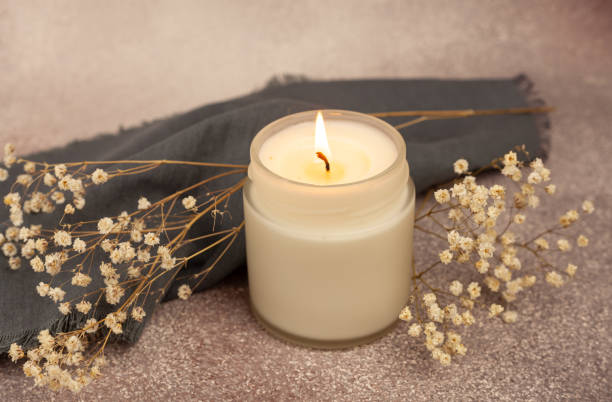 istock Soy wax candle in white glass on a beautiful background 1383985199