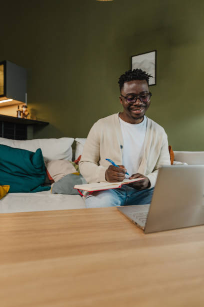 istock Young African American man attends an online course 1383986989