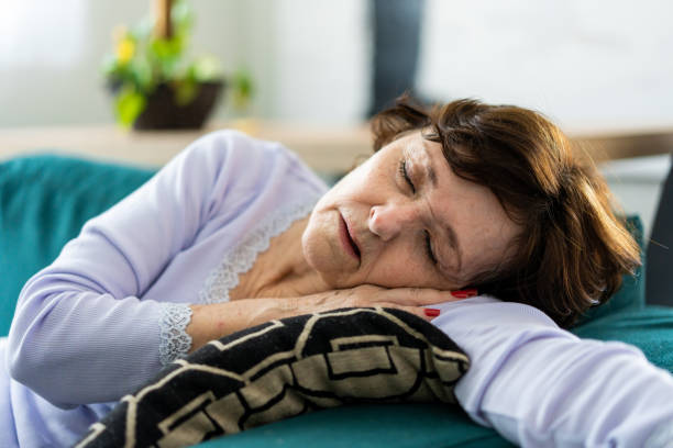istock Sick woman lying on the sofa 1383987213
