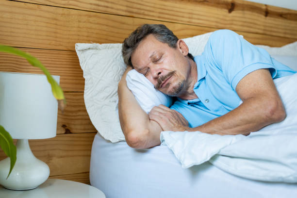 istock Sick man sleeping in bed, sore throat 1383987272