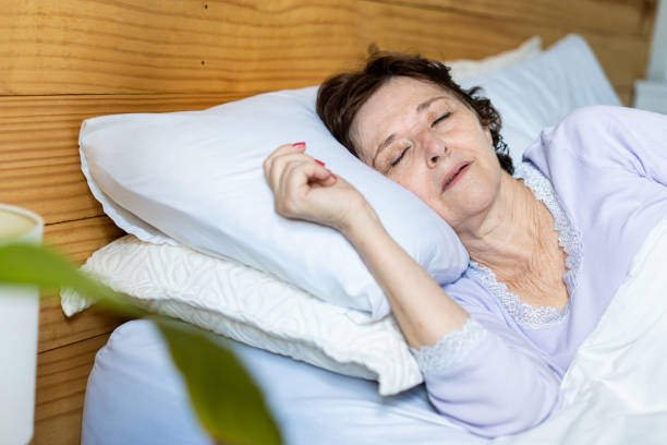 istock Woman with sore throat lying in bed 1383987320