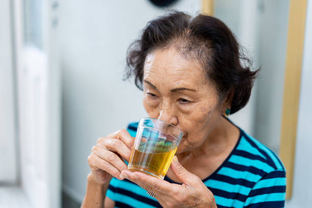 istock Woman with sore throat drinking tea 1383987415