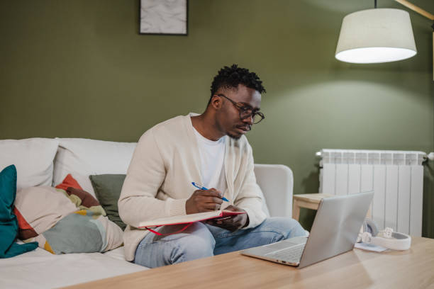 istock Young African American man attends an online course 1383987442