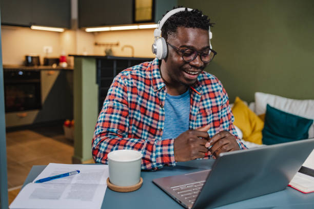 istock African-American man working in home office 1383988825