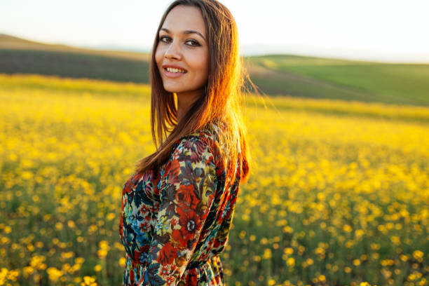 Smiling young girl posing in rape seed field