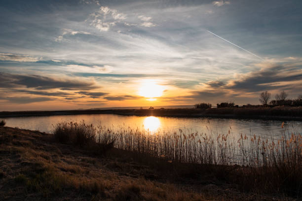 istock Beautiful sunset reflecting in a lake 1383990331