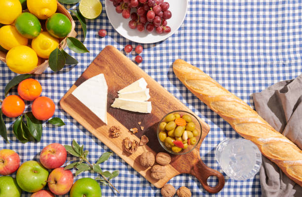 Organic farm to table food on blue checkered tablecloth. Family picnic for foodies.