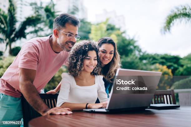 Family Using Laptop At Resting Area Stock Photo - Download Image Now - Teenager, Parent, Family