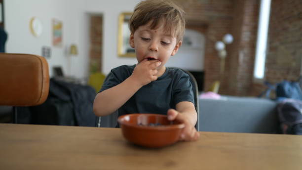 istock Child hands grabbing blueberry from bowl healthy blueberries 1384000177