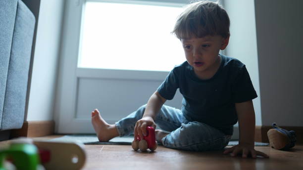 istock Child playing with toy at home 1384000481