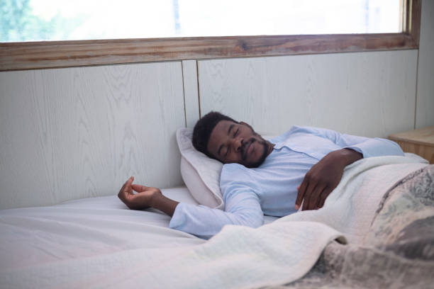 istock Black man with sore throat sleeping in bed 1384000773