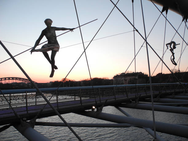 Evening view to Father Bernatek's Bridge with balancing figures by polish sculptor Jerzy Kedziora stock photo