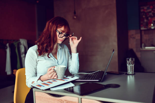 istock Modern Female Administrative Worker Putting On Glasses During Work Conference Session From Home 1384019303