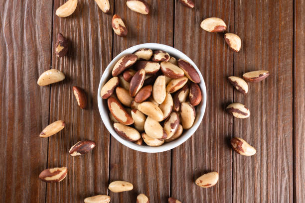 istock Brazil nuts on wooden background 1384028843