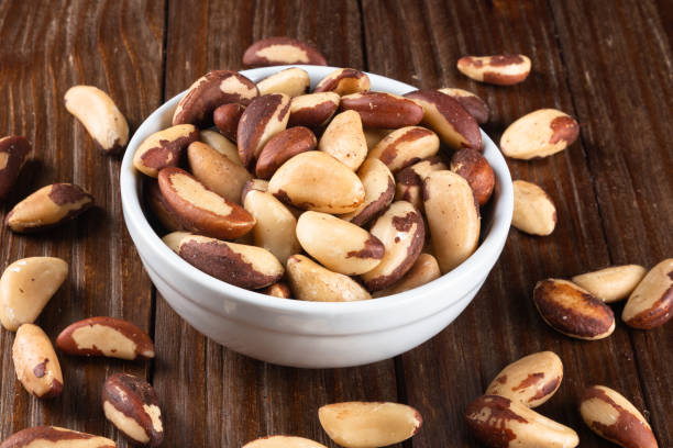istock Brazil nuts on wooden background 1384028848