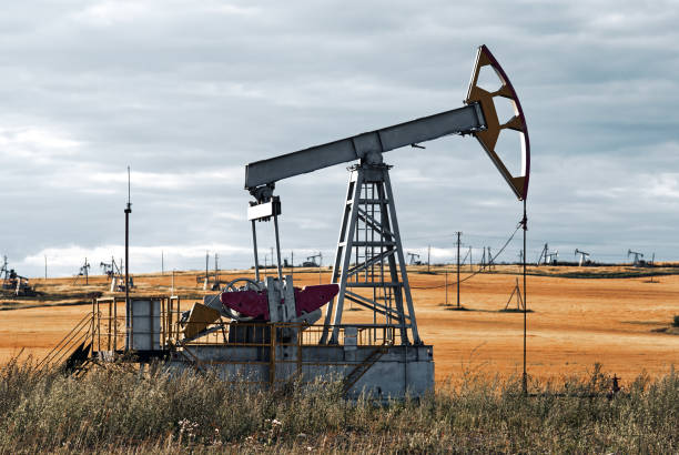 istock Oil pump by yellow grass field 1384036668