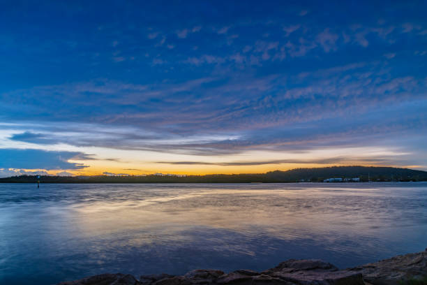istock Sunrise by the bay with stratocumulus clouds 1384052475