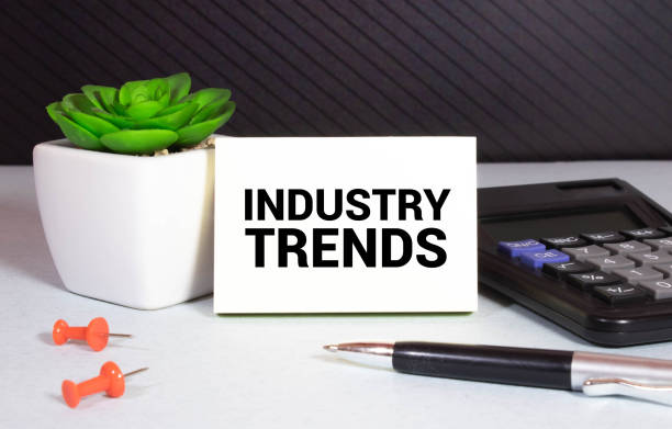 istock INDUSTRY TRENDS text on paper with calculator, notepad, coffee ,pen with graph. 1384054914