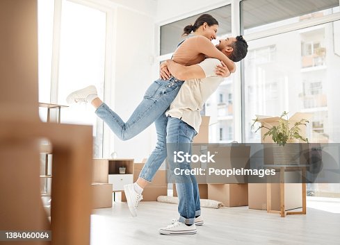istock Shot of a young couple celebrating the move into their new home 1384060064