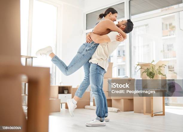 Shot Of A Young Couple Celebrating The Move Into Their New Home Stock Photo - Download Image Now