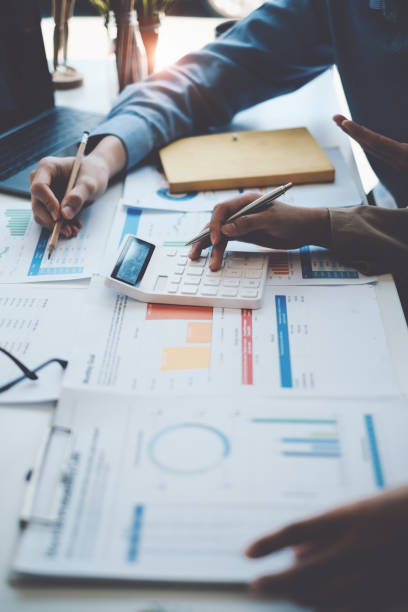 istock Group of IT consultant working together and management big data and analyze financial document of company. 1384073318