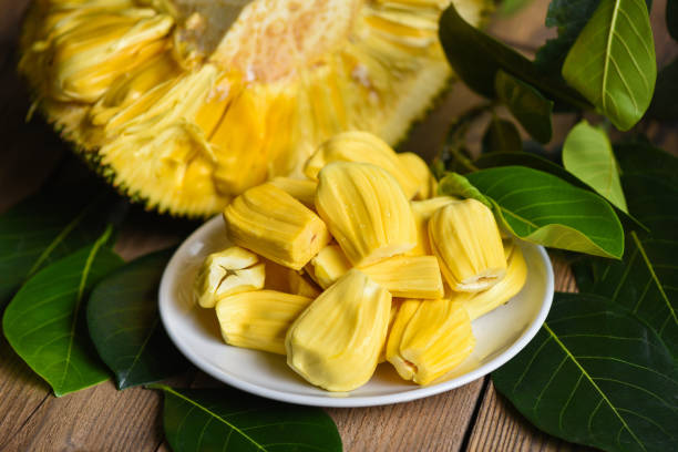 istock Ripe jackfruit peeled tropical fruit fresh from jackfruit tree, jackfruit on white plate with leaf on wooden background 1384078327