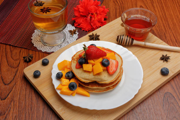istock Hotcakes served ready for breakfast. Hotcakes decorated with strawberries. 1384079552