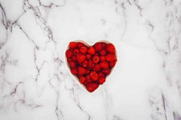 istock Raspberries in Bowl on Marble Counter 1384109888