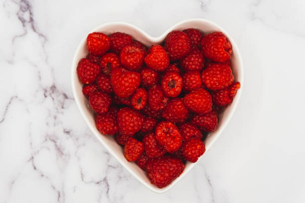 istock Raspberries in Bowl on Marble Counter 1384109892