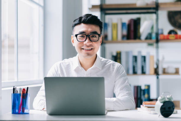 istock Young Asian businessman working at office 1384109929