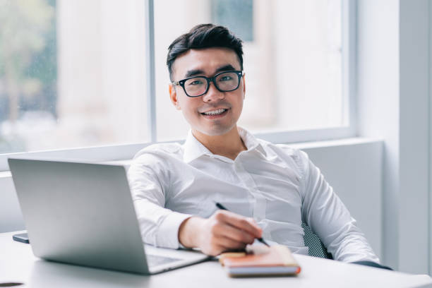 istock Young Asian businessman working at office 1384109932