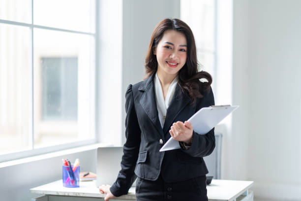 istock Young Asian businesswoman working at office 1384109940