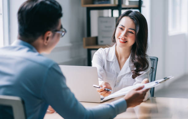 istock Two Asian businesspeople working at office 1384110523