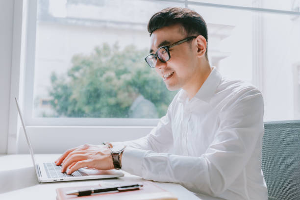 istock Young Asian businessman working at office 1384110693