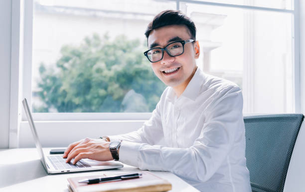 istock Young Asian businessman working at office 1384110698